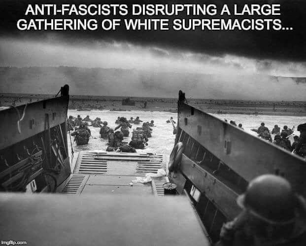 A meme of Robert Sargent's photograph Into the Jaws of Death, with text that states "Anti-fascists disrupting a large gathering of white supremacists"